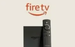 Amazon Fire TV Stick beside its remote